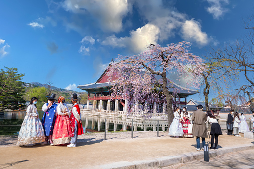 Seoul, Korea - April 05, 2021: Korean couple with Korean traditional dress Hanbok in Gyeongbokgung palace in spring, seoul, south korea.