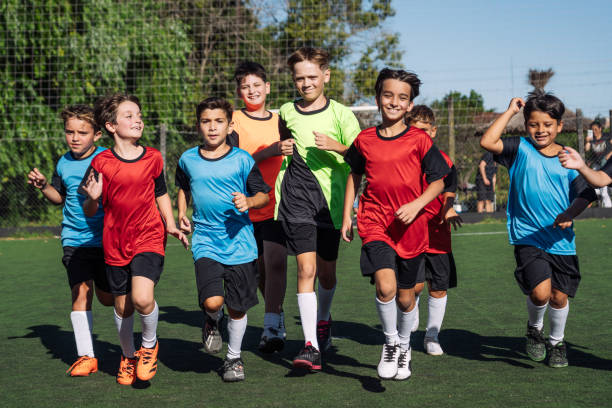istock Young Soccer Players Running Together on Field in Teamwork 1997716784