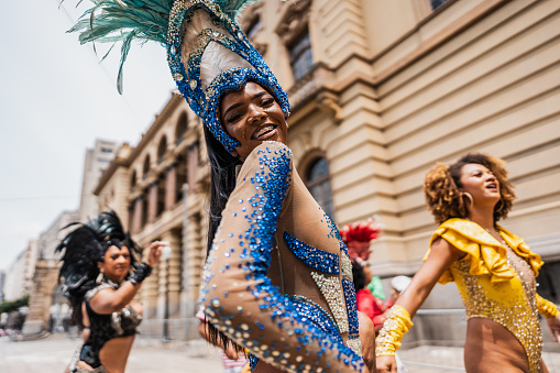 Portrait of a young woman having fun at a street carnival party