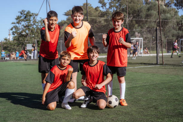istock Cheerful Young Soccer Players Celebrating Victory on Field 1997727596