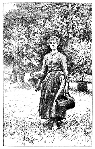 Young woman watering the flowers in the garden