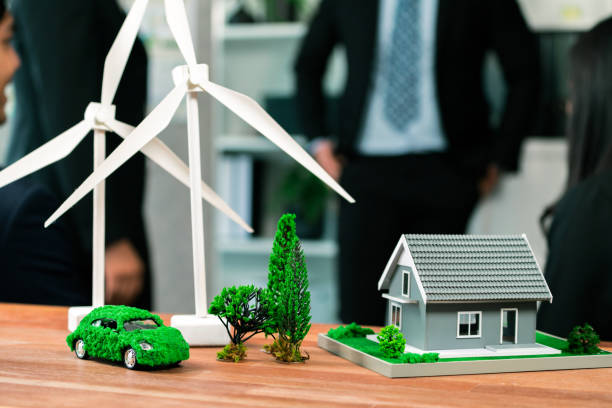 istock EV car model with mockup wind turbine on blurred background meeting. Quaint 1997732364