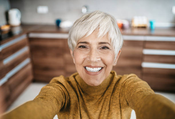 istock Happy senior woman working from home 1997802999