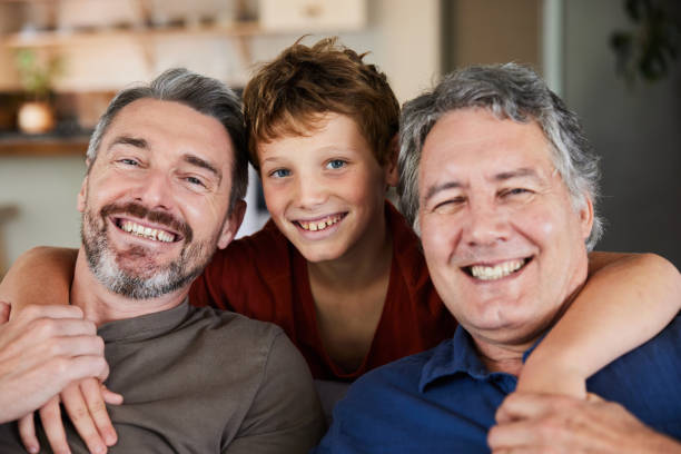 istock Smiling man sitting at home with his young son and mature dad 1997810401