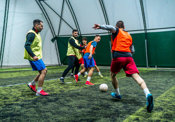 istock Group of men playing soccer 1997824938