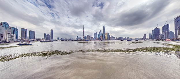 Panoramic view of the Huangpu River and the Shanghai skyline from the Bund during the day