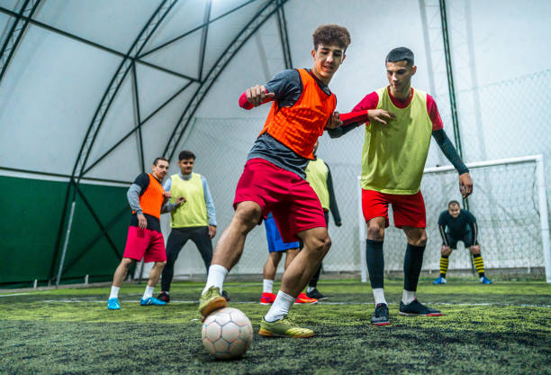 istock Group of men playing soccer 1997830371