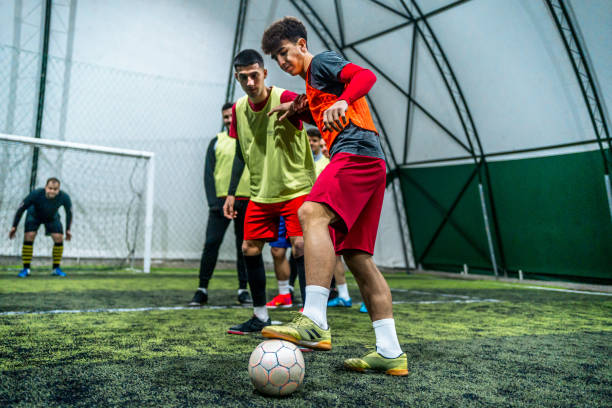istock Group of men playing soccer 1997834942