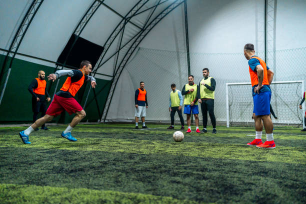 istock Soccer player kicking ball at goal 1997837070