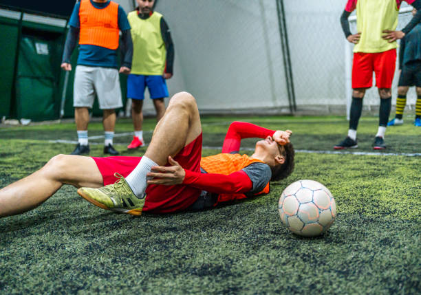 istock Soccer player holding his injured leg 1997840841