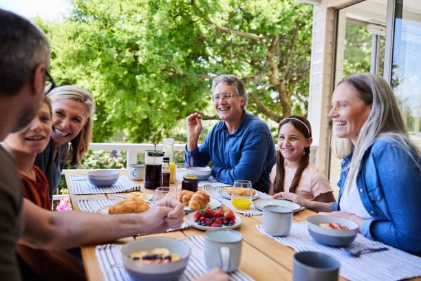 istock Multi-generation family laughing over breakfast on their patio at home 1997843465