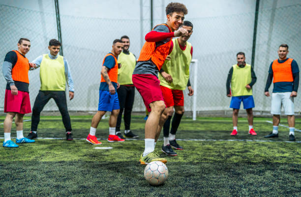 istock Group of men playing soccer 1997845633