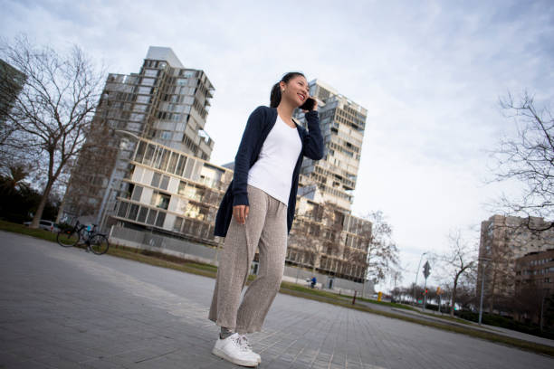 istock Young asian woman using cell phone 1997850024