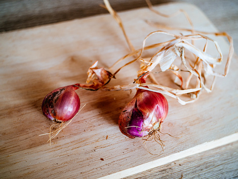 White onions on a wooden cutting board