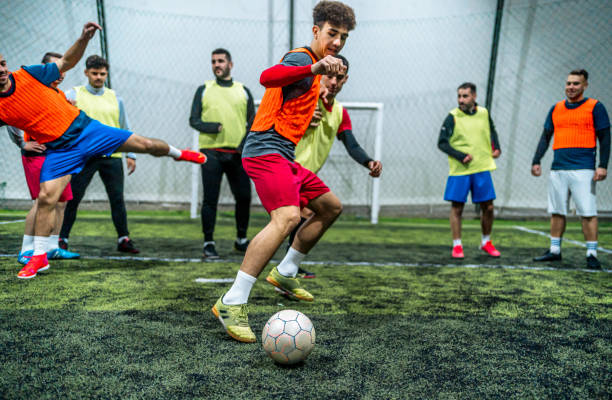 istock Group of men playing soccer 1997853750