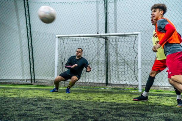 istock Goalkeeper defending goal in soccer game 1997855376