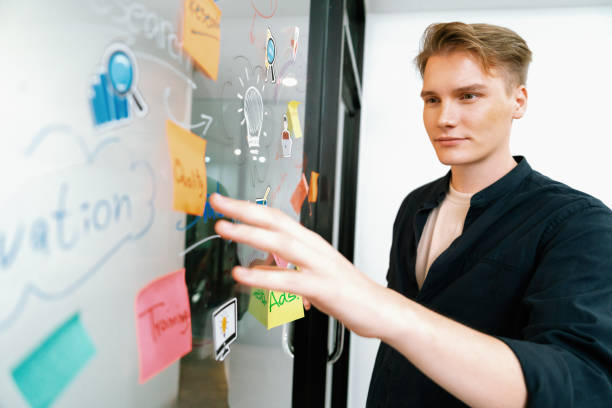 istock Professional businessman brainstorm idea on glass white board. Immaculate. 1997862300