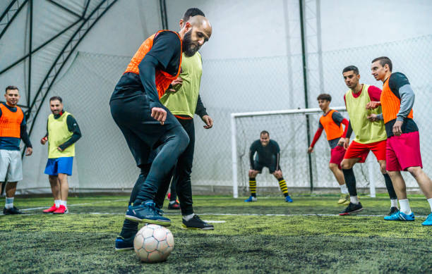 istock Group of men playing soccer 1997869054