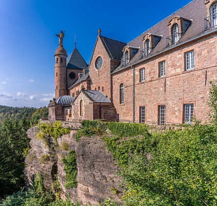Alsatian Vineyard. Panoramic view of the facade of the Sanctuary of Mont Sainte Odile and the forest along the wine route at sunrise