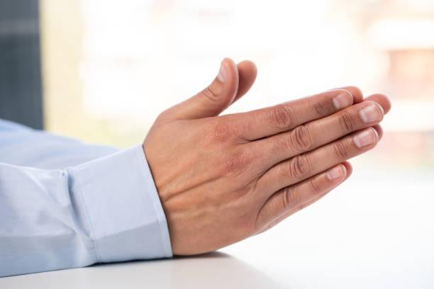 Close up of hands praying, begging and hope with the hands of a business man together in prayer or asking for help and assistance. Hoping and wishing for an opportunity, a blessing or guidance in religion and faith