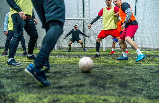 Soccer player kicking ball at goal