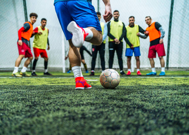 istock Player kicking ball over the human defensive wall 1997873437