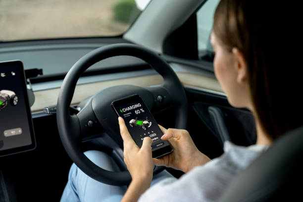 istock Young woman inside the vehicle, checking EV vehicle's application. Exalt 1997881213