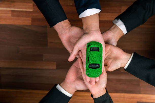 istock Business people synergy holding EV car model. Quaint 1997882395