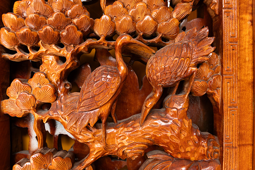Traditional Vietnamese wooden carvings in Buddhist temples in the UNESCO World Heritage site of Hoi An, Vietnam.