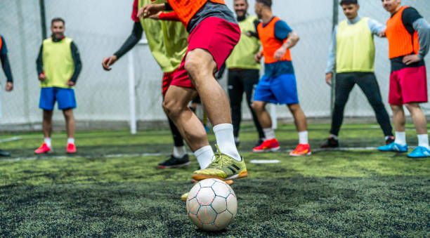 istock Group of men playing soccer 1997886767
