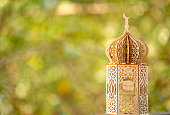 Vintage lantern lamp on natural background with copy space for greeting Text, Eid theme poster