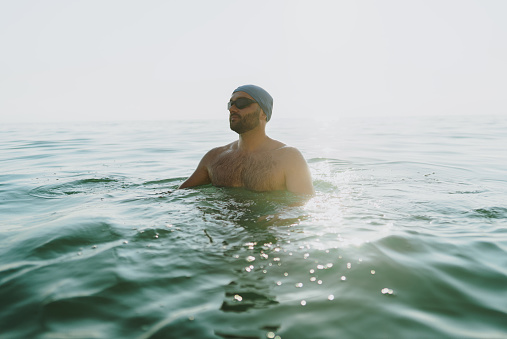 A 17 Year Old Teenage Boy Walking Out Of The Sea