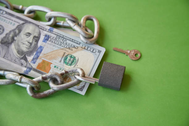 istock Hundred-dollar bills with a chain on them and an open lock, unlocking funds, unlocked money, unlocking an account 1997954483