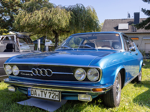 Weiterstadt, Germany September 24, 2023: Audi 100 Coupe S in blue at Chromblitz in Weiterstadt at Braunshardt Castle; spoke rims