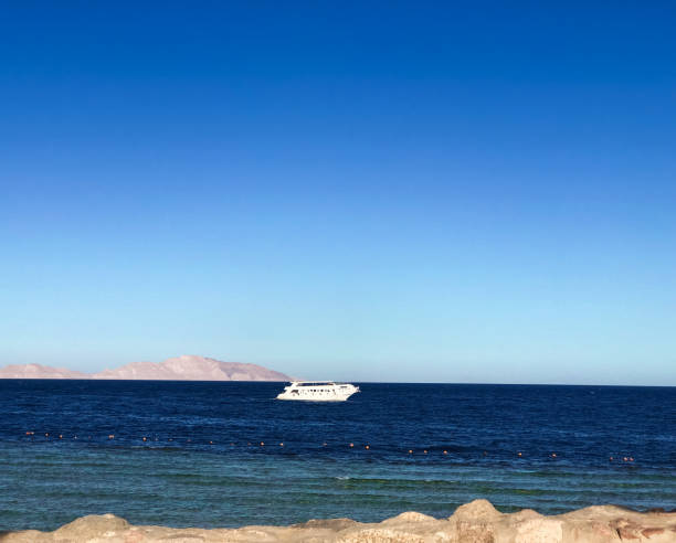Ship yacht boat on horizon line Egypt. panoramic view blue sea surface far from coast. Natural background sunny day sky. Template free space wallpaper mockup. Summer background calm marine Red sea