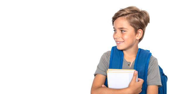 istock Smiling boy looks at the side with books and backpack isolated on white background 1997974894