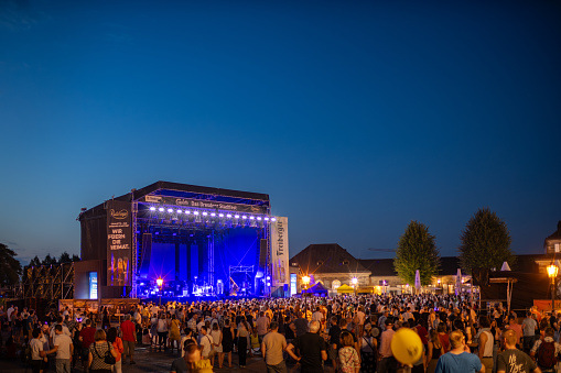 Dresden, Event stage and crowd at the Canaletto city festival. Live music event in the old town attracts a lot of people. Theaterplatz square as an event location.