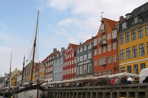 Traditional multicolored houses and old ships in old town Nyhavn canal of Copenhagen. Copenhagen, Denmark - August 20, 2008