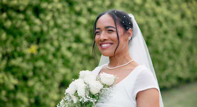 Wedding in garden, bride with smile and bouquet of roses for celebration of love, future and commitment. Outdoor marriage ceremony, excited and happy woman in with flowers, sunshine and floral event