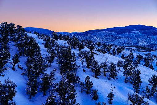 Snowy Mountain Scenic - Winter landscape with fresh snow and warm glow in sky.