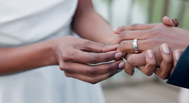 Couple, holding hands and ring for marriage, commitment or wedding in ceremony, love or support. Closeup of people getting married, vows or accessory for symbol of bond, relationship or partnership