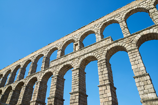 View from below the Roman aqueduct in the city of Segovia, Castilla Leon in Spain.