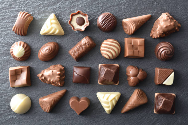 istock Assortment of chocolates placed in a pattern on slate plate 1998017223