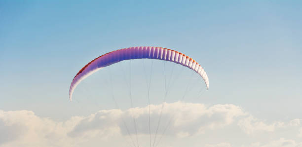 istock Paraglider sail on a blue sky background 1998027847