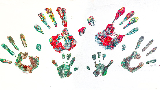 Hands of a family painted on white wall
