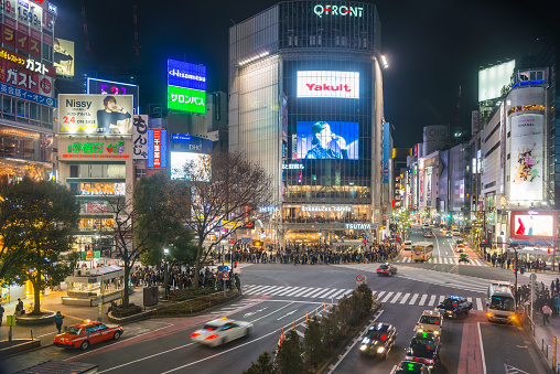 View over the iconic Shibuya Crossing and the crowds of commuters and shoppers on the streets below the colourful neon signs in the heart of Tokyo, Japan’s vibrant capital city.