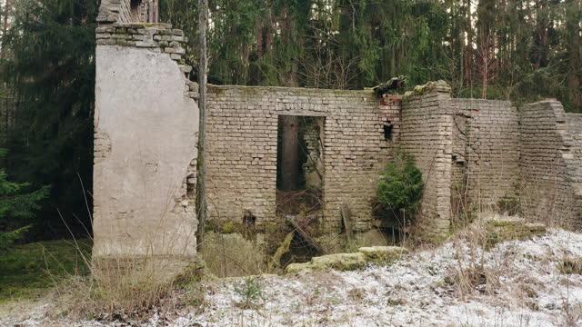 Old ruined brick house in remote wild green countryside