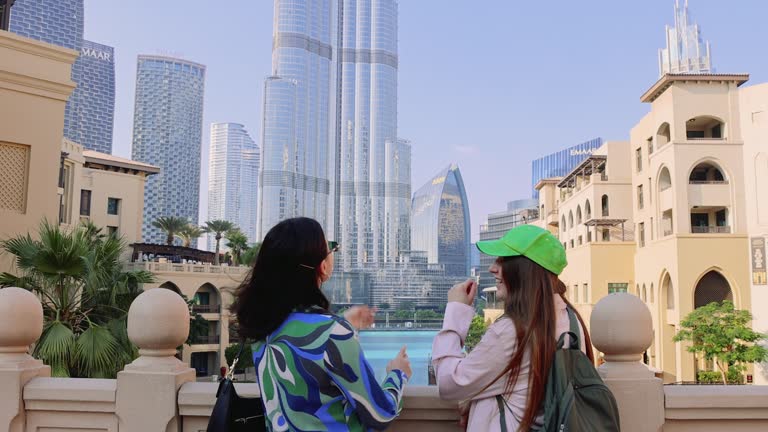 Two Happy Women Friends Tourists Exploring Dubai Downtown