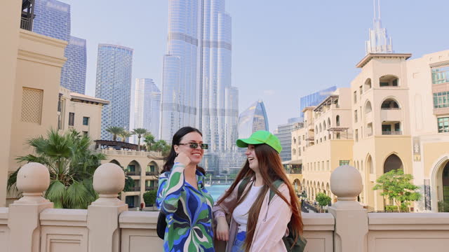 Two Happy Women Friends Tourists Exploring Dubai Downtown