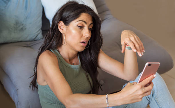 istock Sad Woman  using her phone at home 1998071754